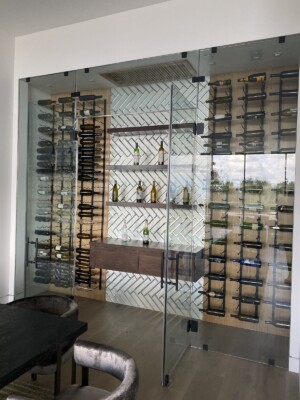 The team used a glass door so everyone can see the entire collection with the modern wine racking without any obstruction. Using the same wooden floors as the dining room was the perfect choice to really make it look like the cellar is not a separate room, but a stylish part of the dining room.